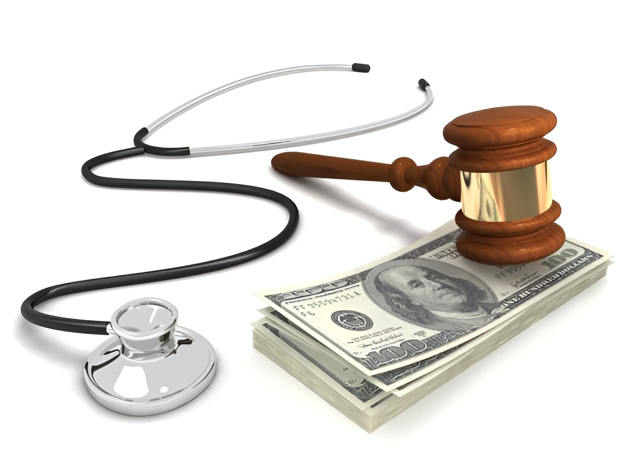 cash bundle, wooden gavel, and stethoscope